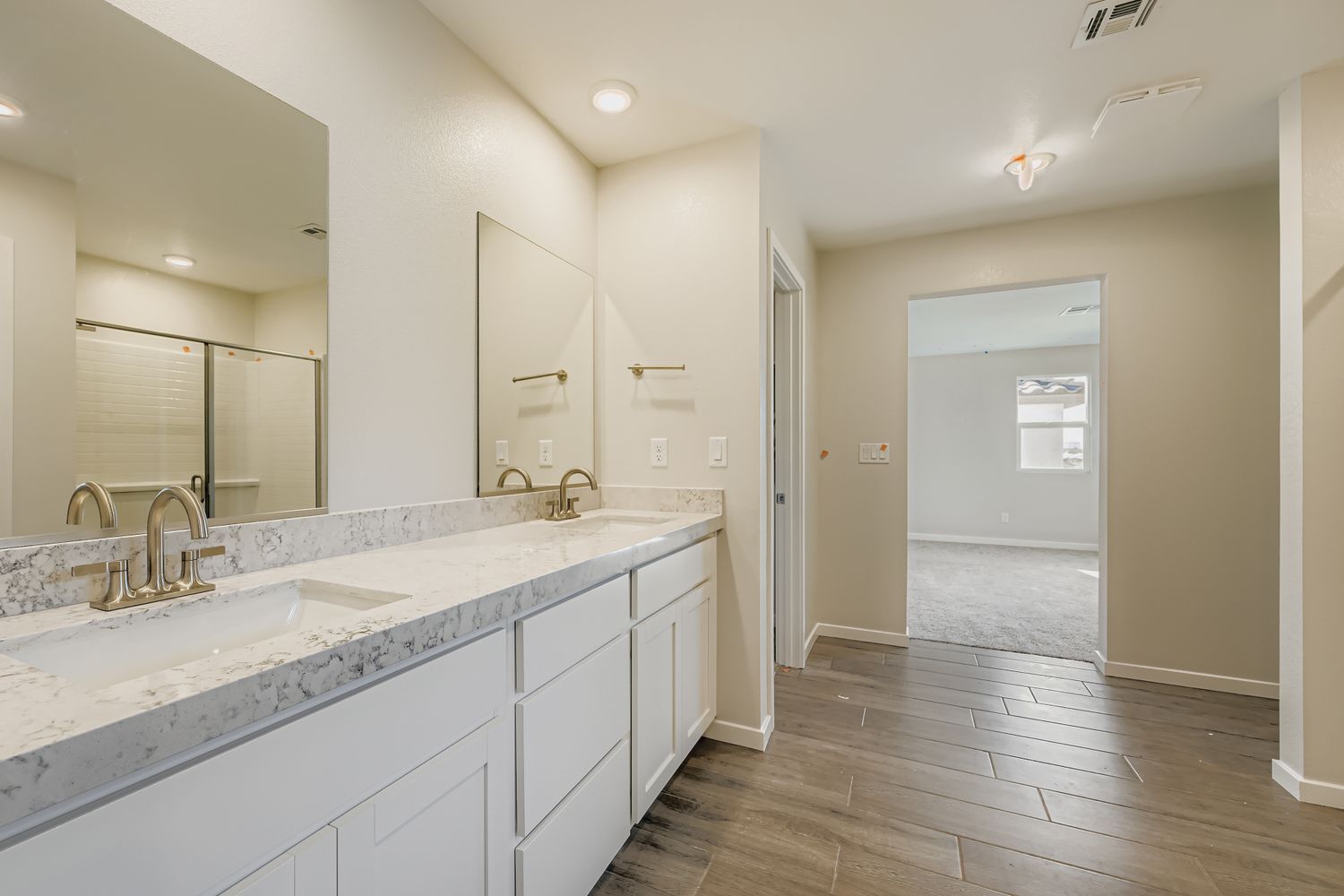 A bathroom with white cabinets.