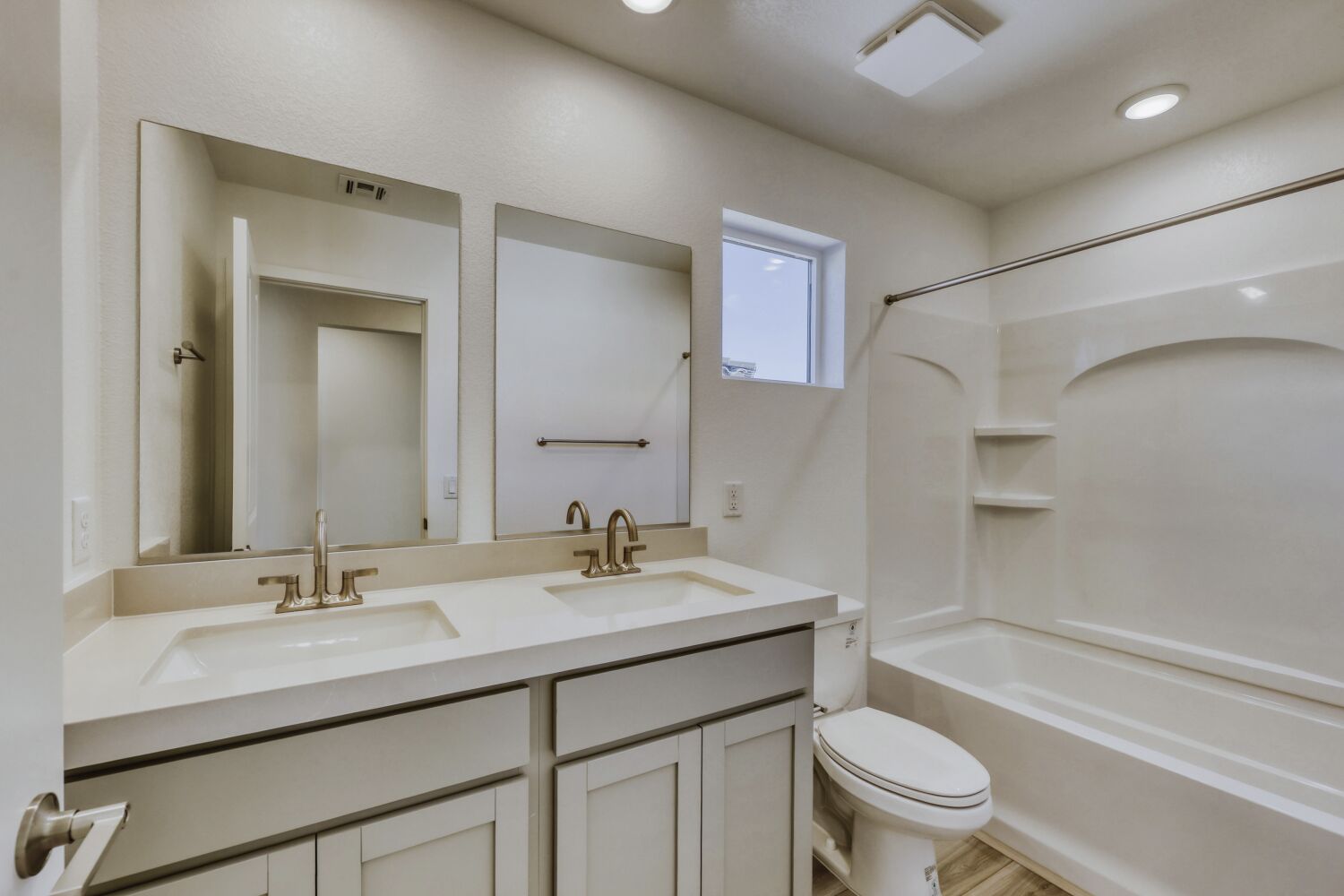 A bathroom with a tub sink and toilet.