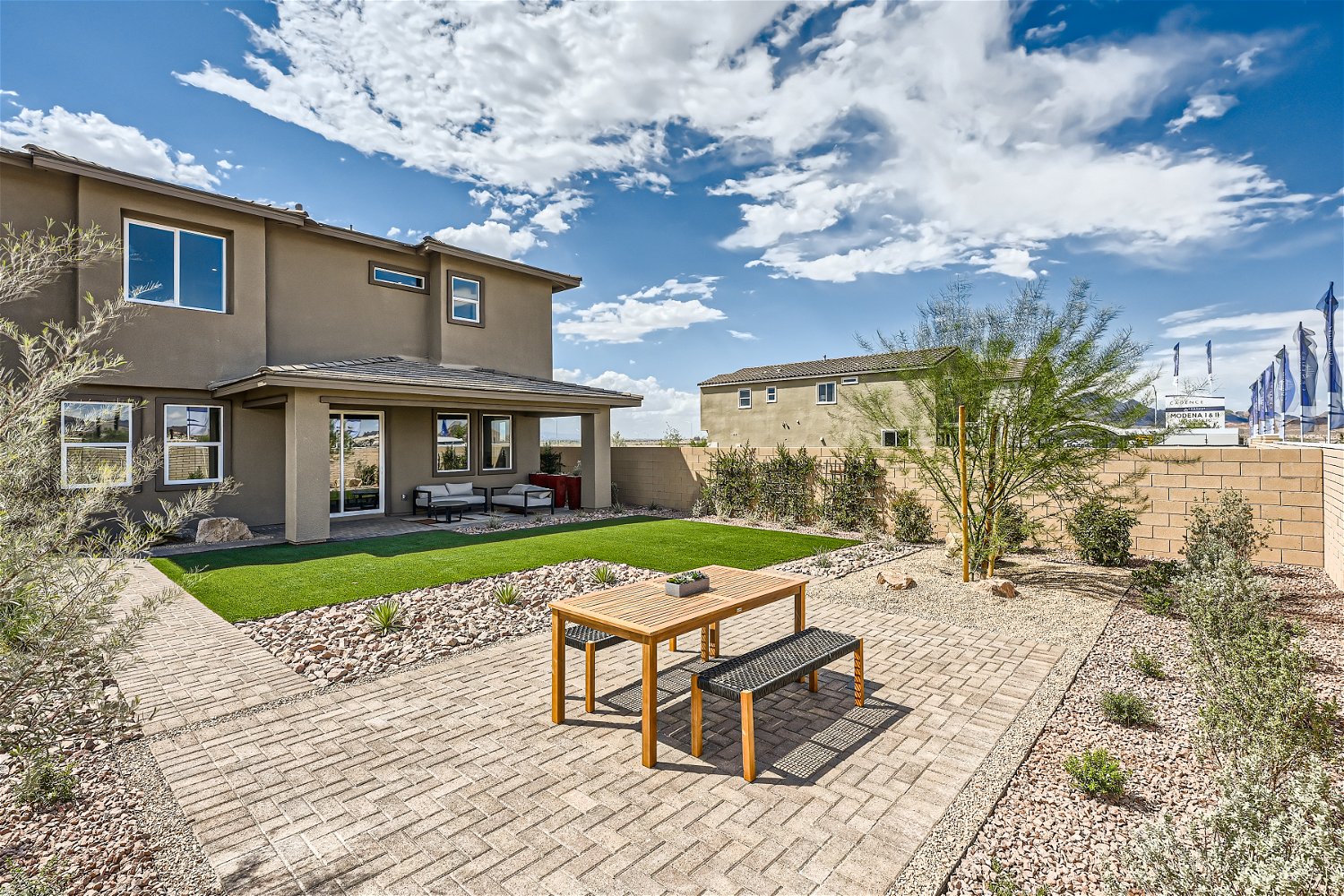 A patio with tables and chairs in front of a building.