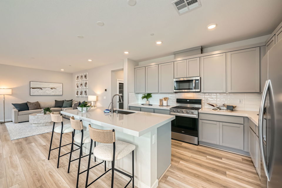 A kitchen with a bar and a table.