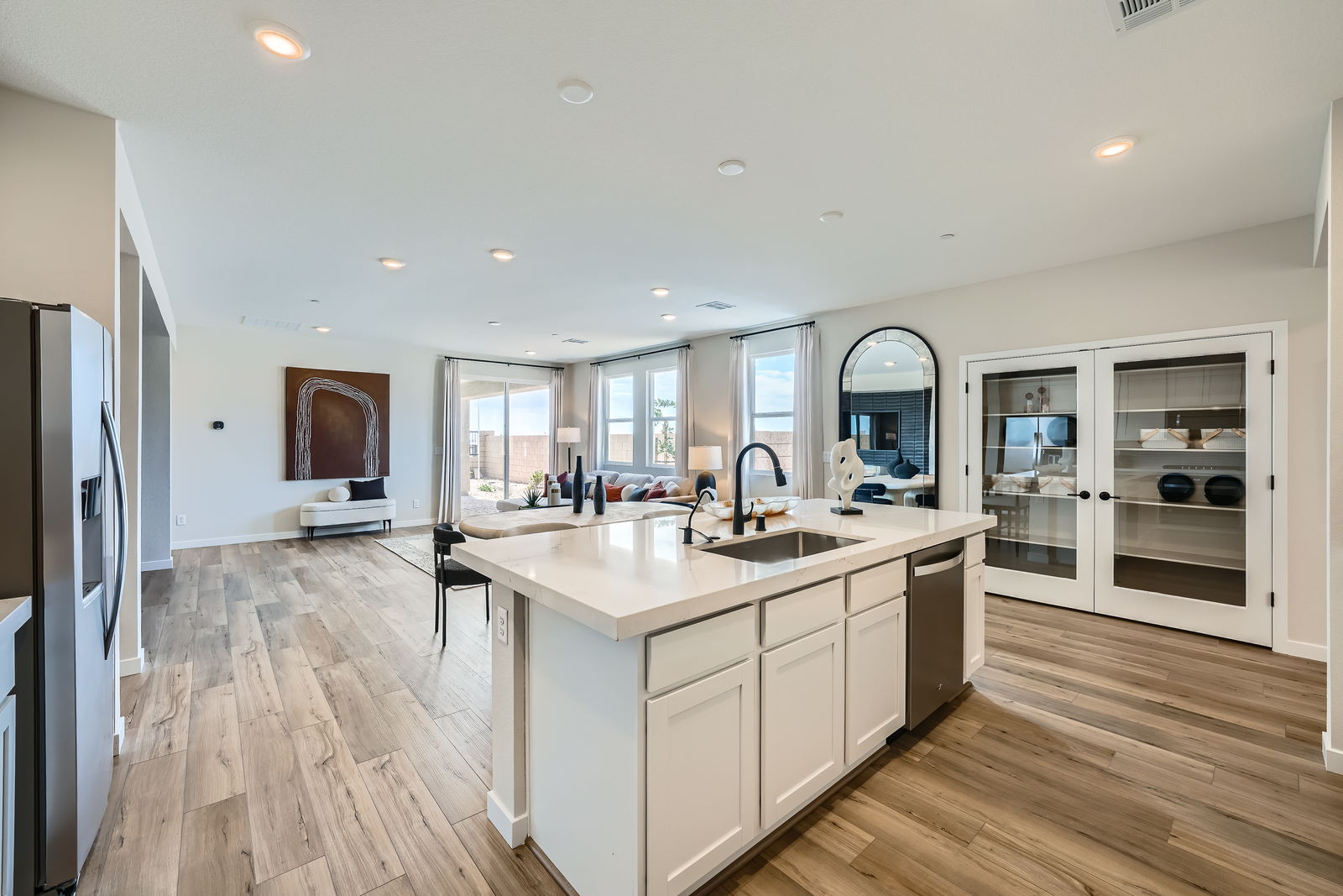 A kitchen with white cabinets.
