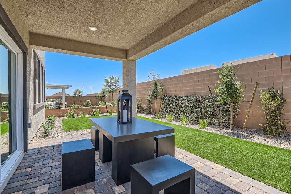 A table and chairs outside a building.
