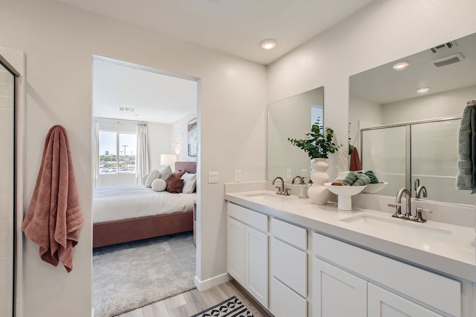 A bathroom with a bed and a sink.