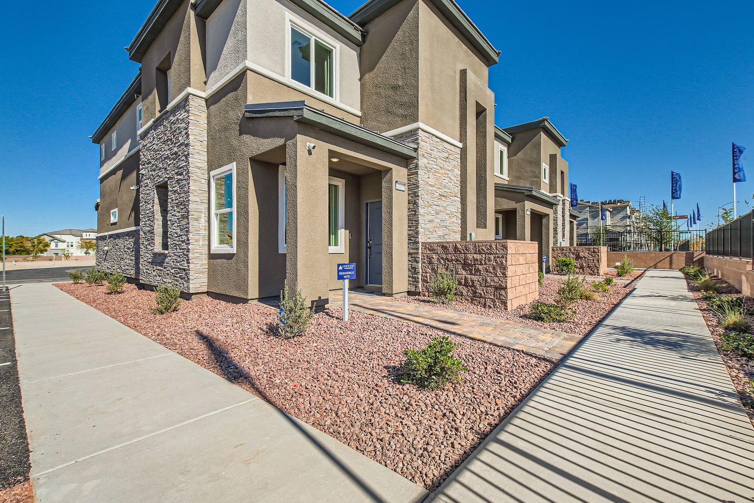 A stone building with a brick walkway.