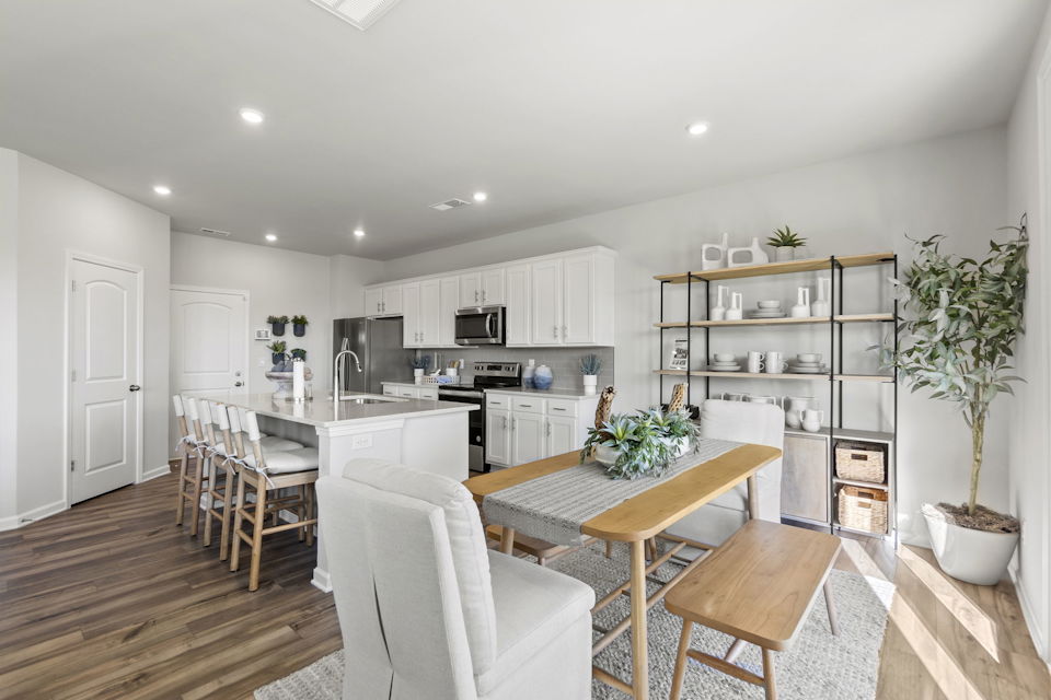 A kitchen with white cabinets.