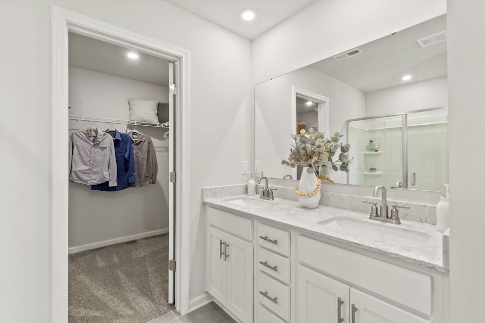A bathroom with a shower and sink.