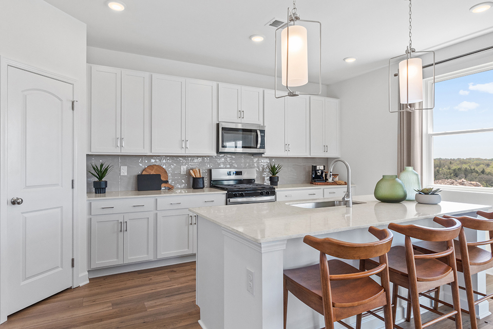 A kitchen with white cabinets.