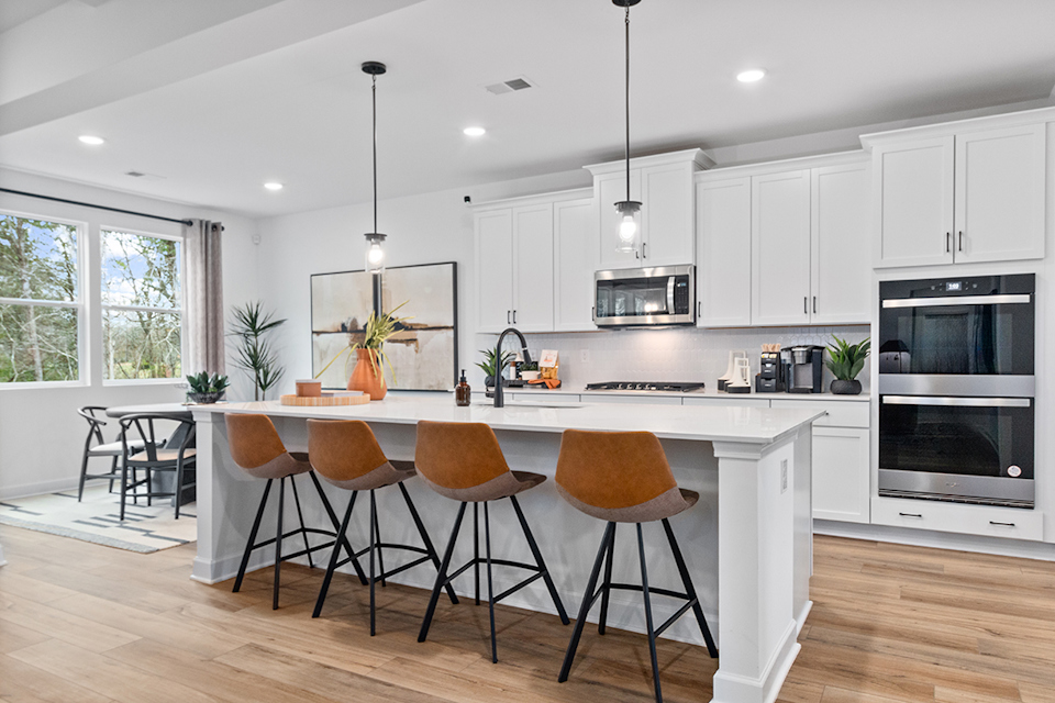 A kitchen with white cabinets.