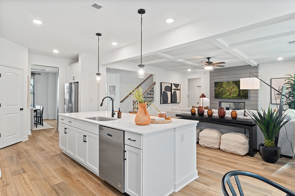 A kitchen with white cabinets.