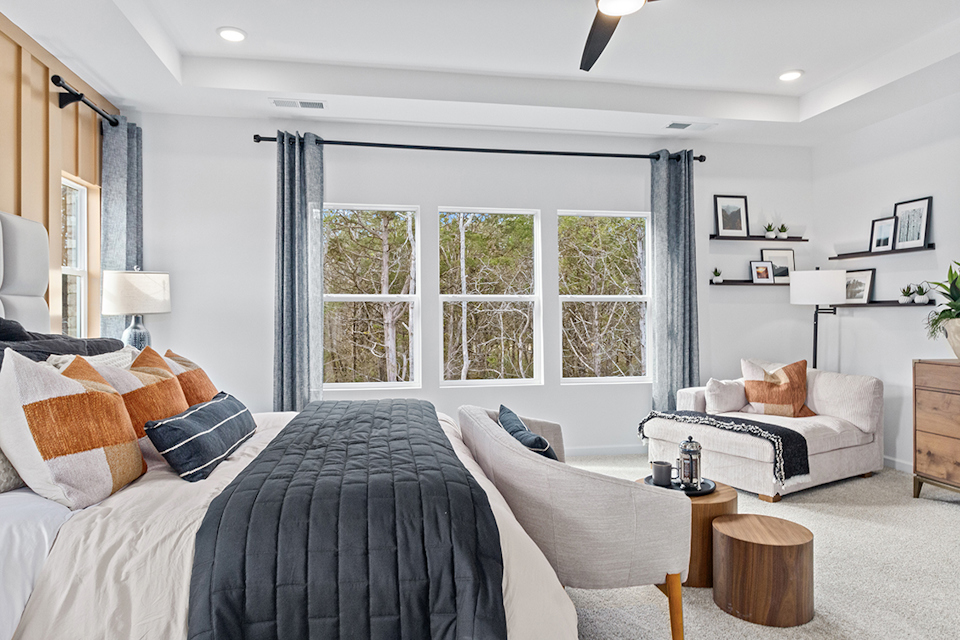 A bedroom with a large window.