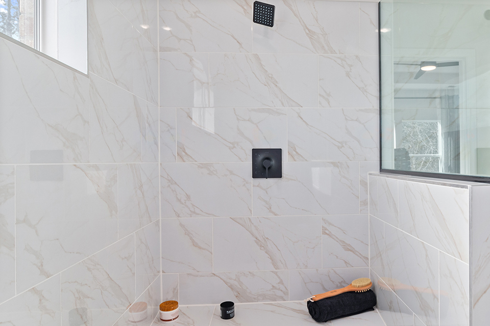 A bathroom with a tile wall.