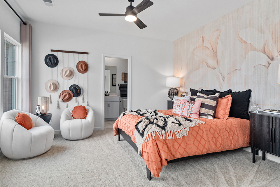 A bedroom with a bed and a fan.