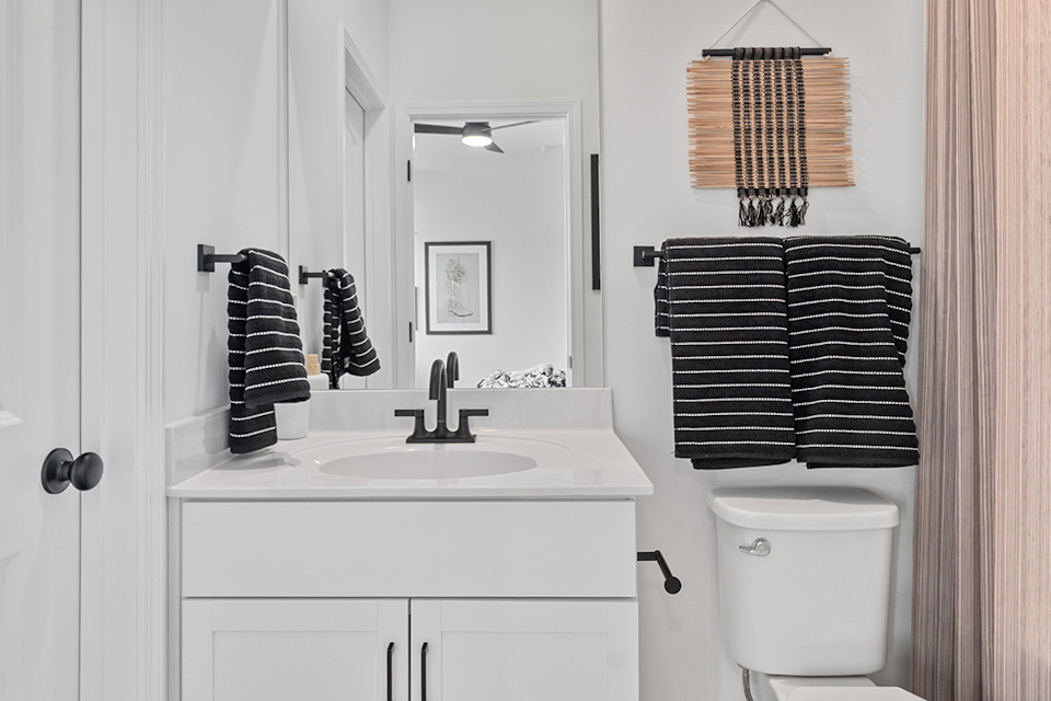 A bathroom with a sink and a mirror.