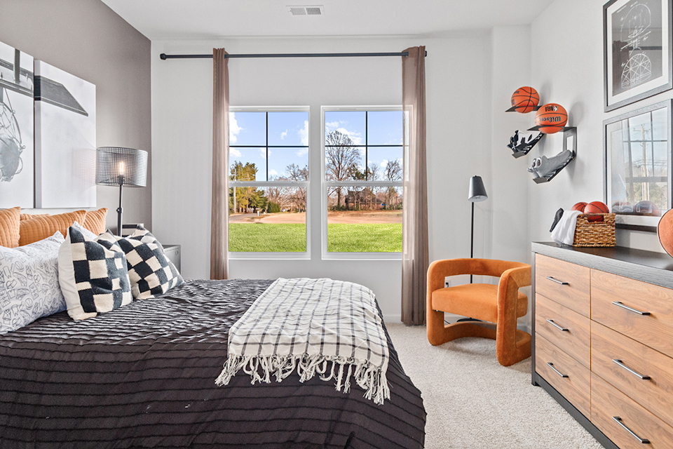 A bedroom with a large window.