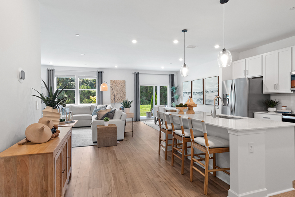 A kitchen with a dining table and couches.
