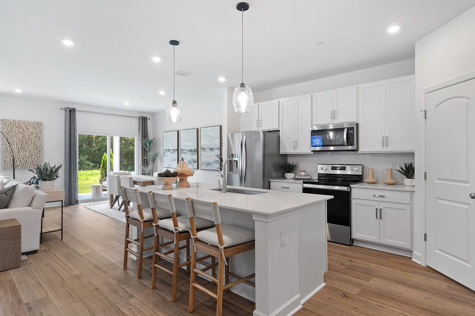 A kitchen with white cabinets.