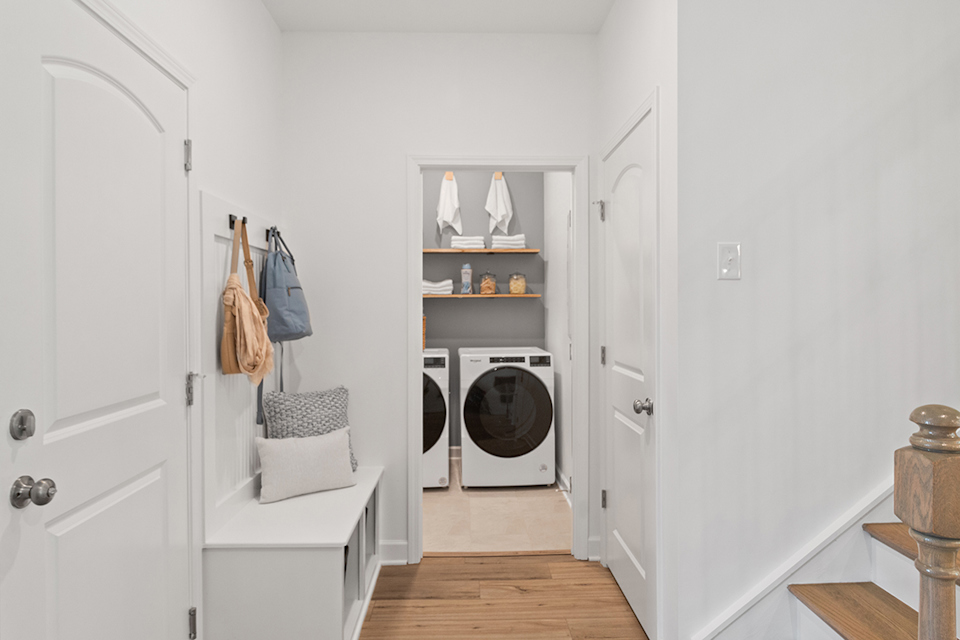 A room with a white door and a white shelf with a fan.