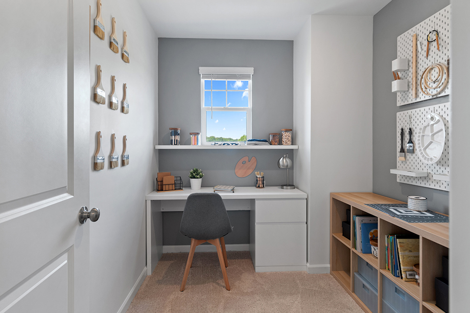 A room with a desk and a chair.