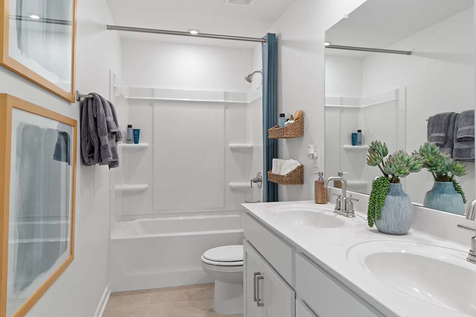 A bathroom with a tub sink and toilet.