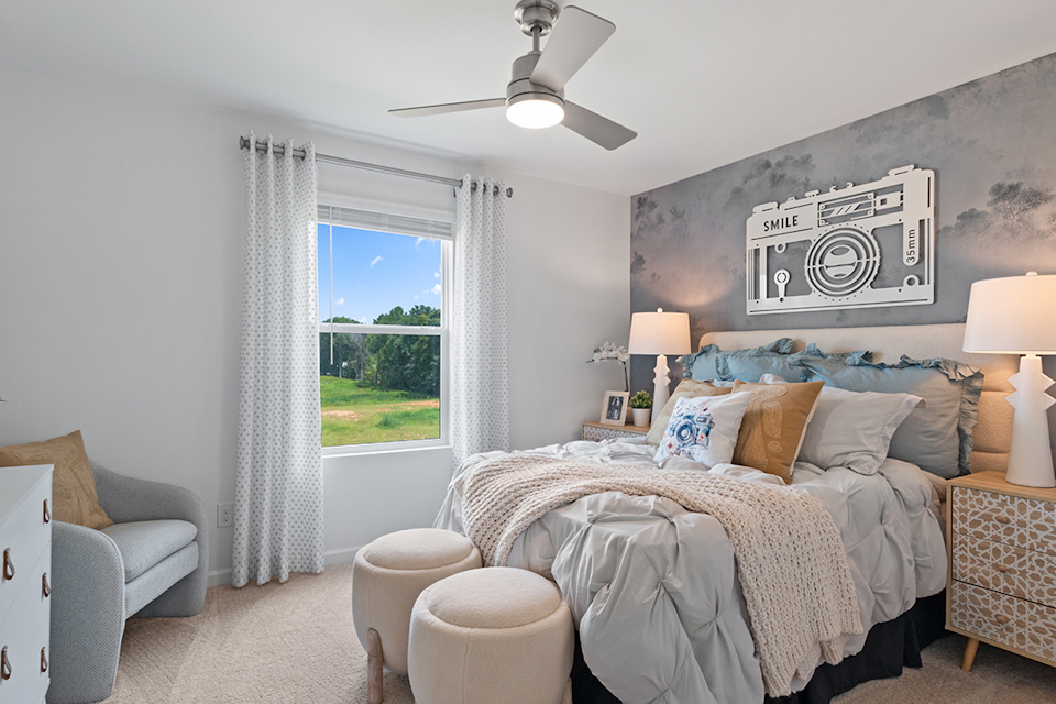 A bedroom with a large window.