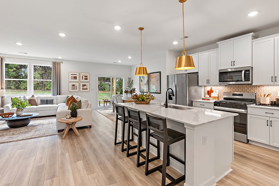 A kitchen with a wood floor.