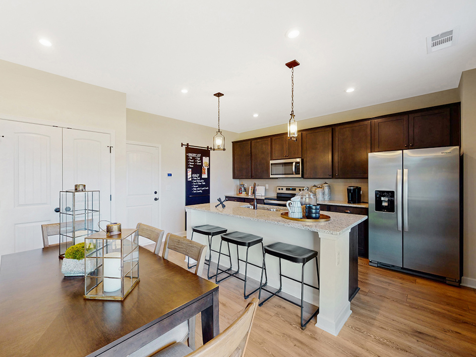 A kitchen with a table and chairs.