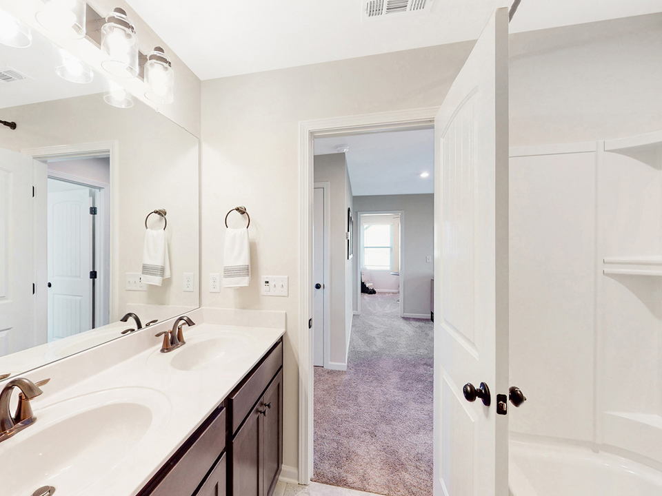 A bathroom with a large mirror.