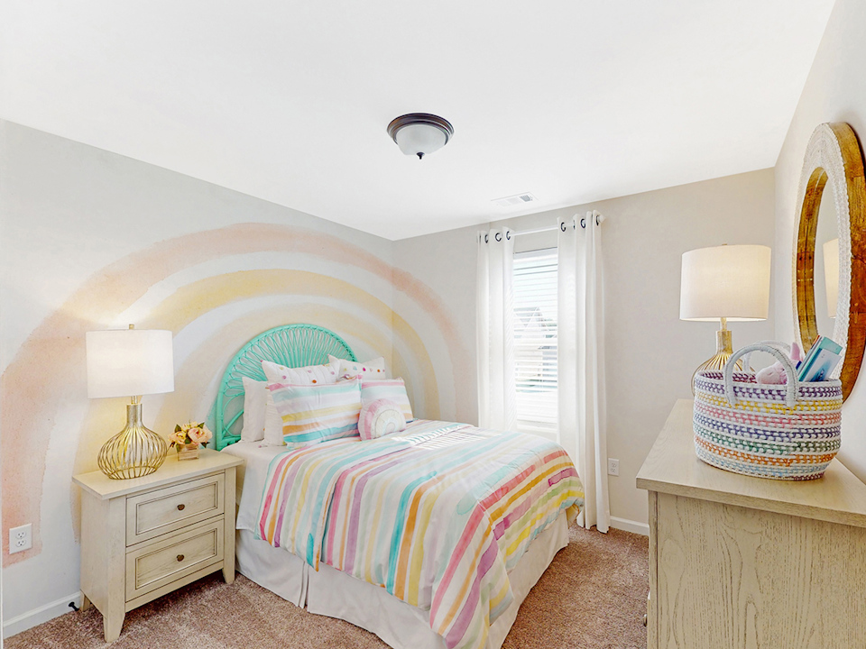 A bedroom with a bed and a mirror.