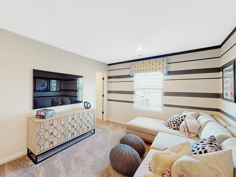 A living room with a couch and a tv.