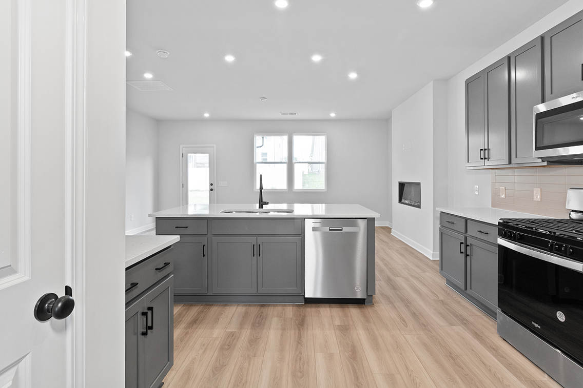 A kitchen with black cabinets.