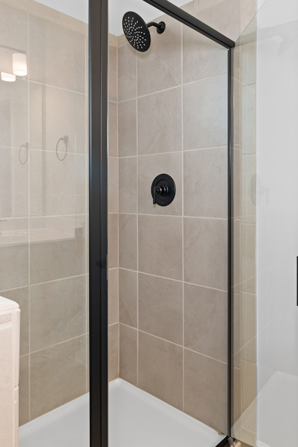 A shower with a glass door.