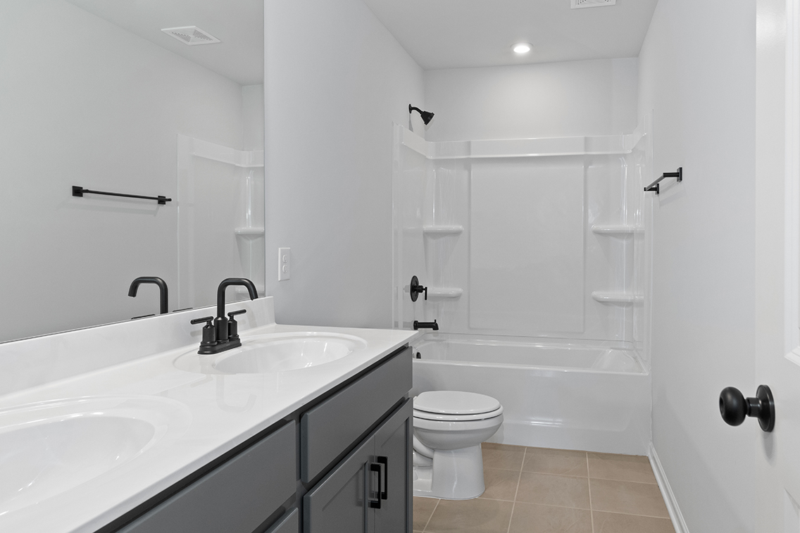 A bathroom with a tub sink and toilet.
