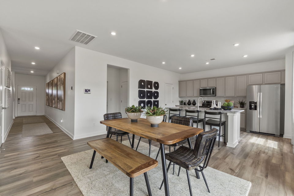 A kitchen with a dining table.