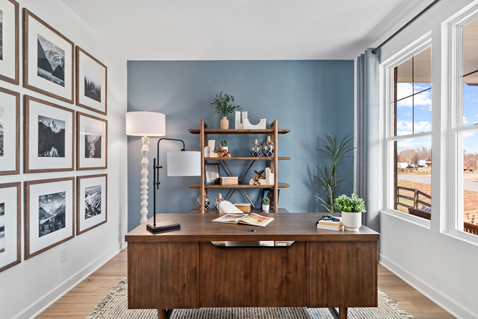 A desk with a lamp and books on it.