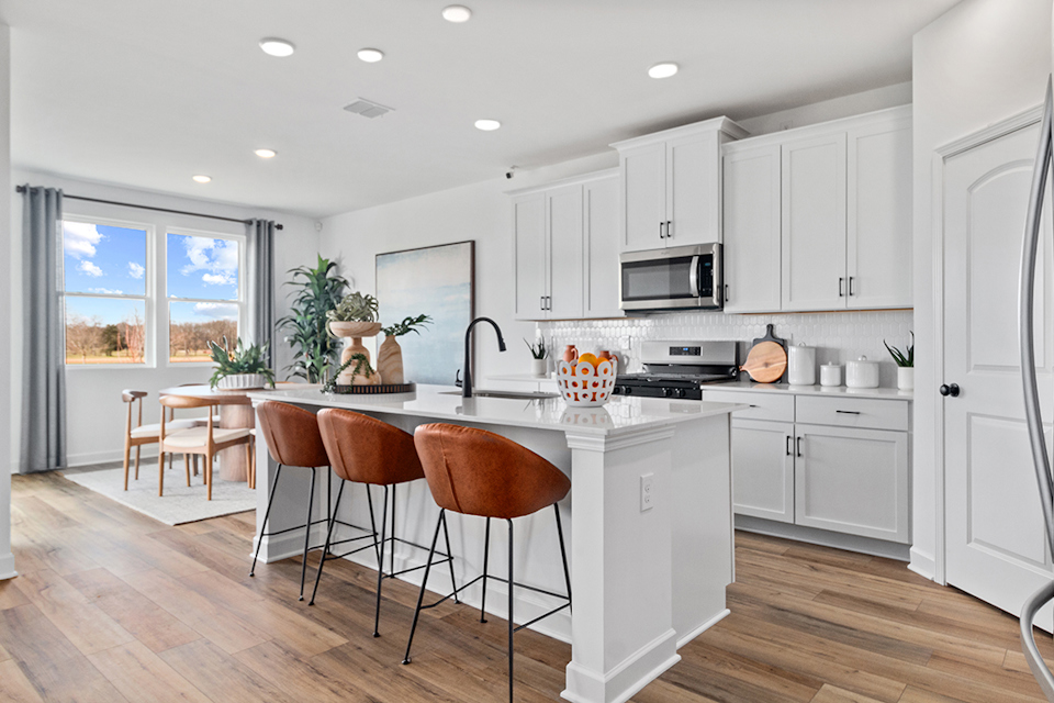 A kitchen with white cabinets.