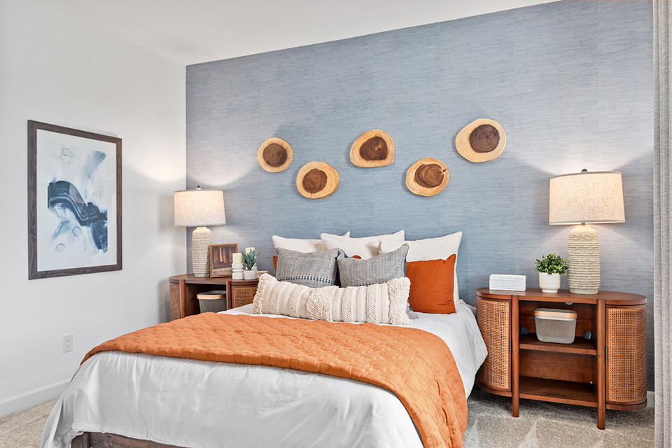 A bed with a blue wall.