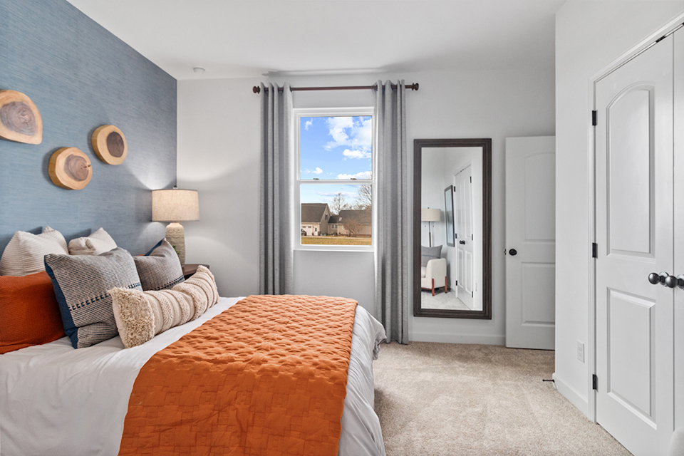 A bedroom with a large window.