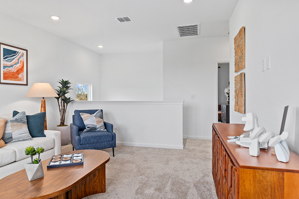 A living room with a couch and a table.