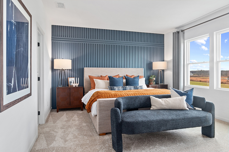 A bedroom with a bed and a couch.