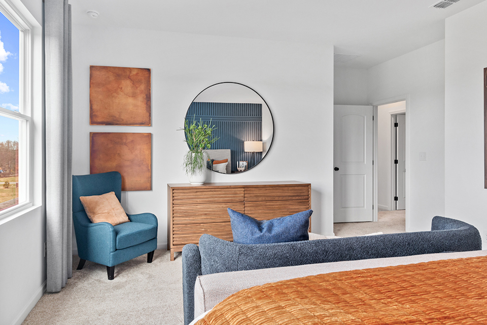 A room with a bed and a chair.