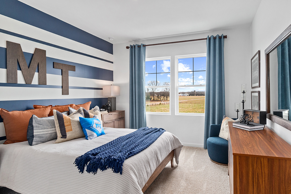 A bedroom with a bed and a desk.