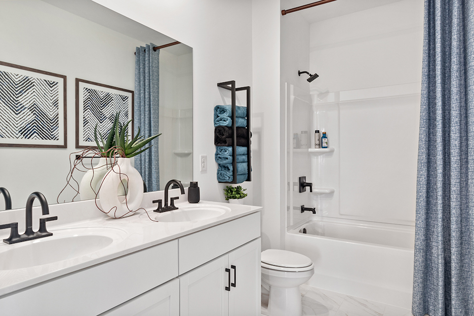 A bathroom with a sink toilet and bathtub.
