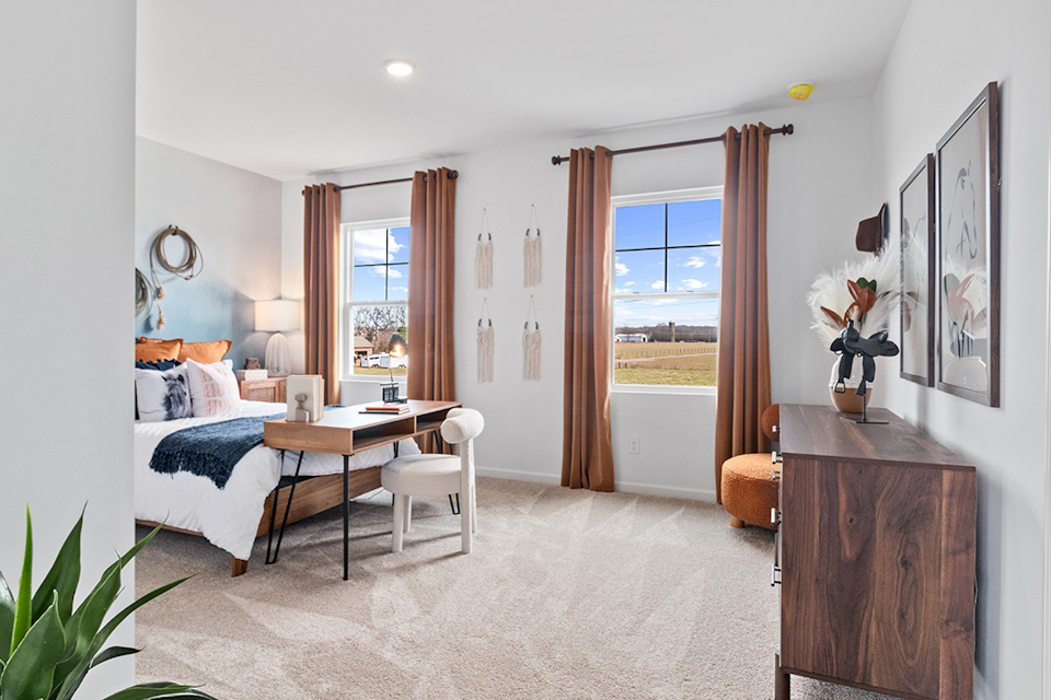 A bedroom with a large window.