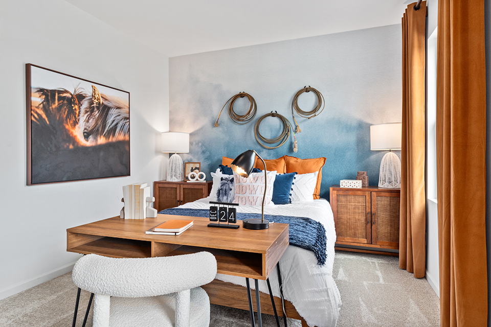 A bedroom with a bed and a desk.