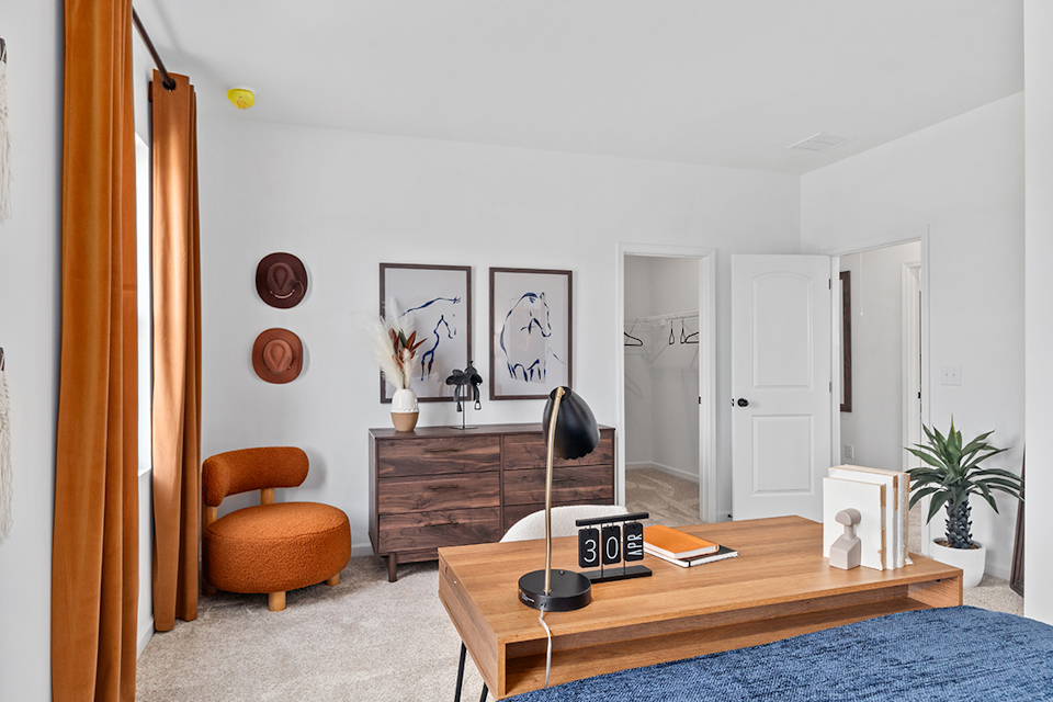A room with a desk and a chair.