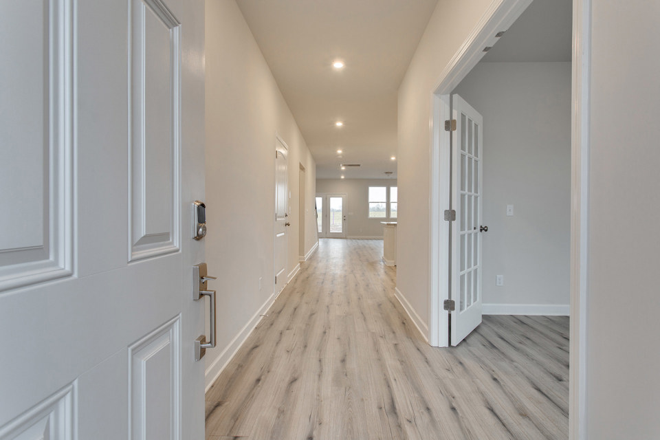 A hallway with white doors.