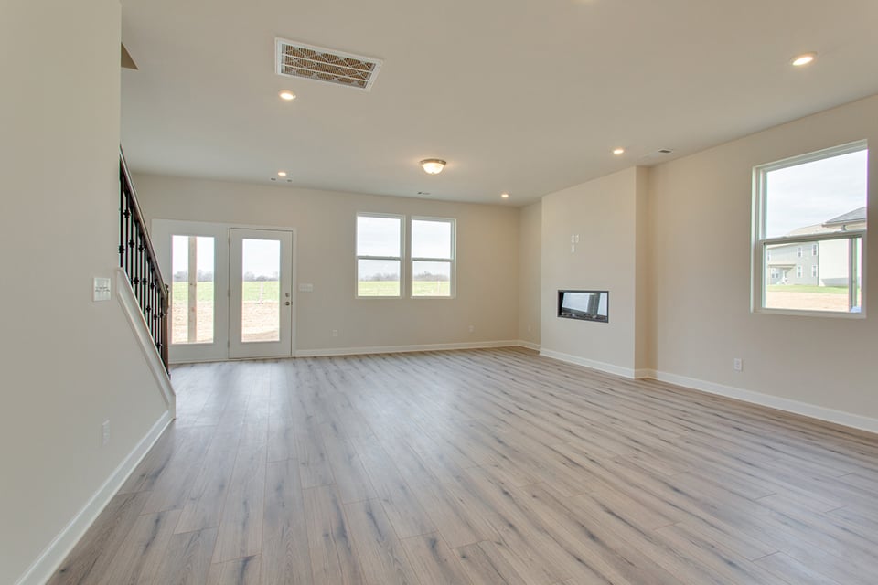 A room with a wood floor and windows.