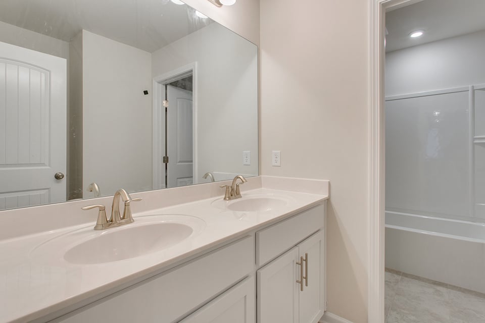 A bathroom with a sink and a mirror.