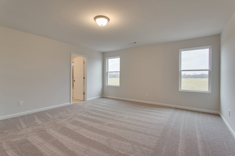 A room with a wood floor and a door.