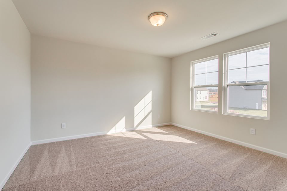 A room with a window and a carpet.